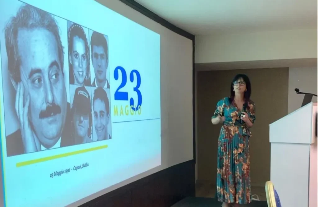 Relatrice al XXV Congresso Nazionale AITRI, Palermo 2026, davanti alla slide della commemorazione del 23 maggio